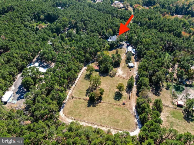 a backyard of a house with lots of green space and outdoor seating