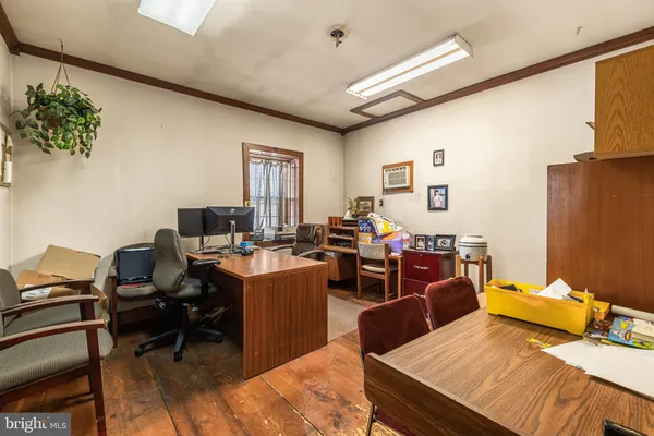 a view of a workspace with furniture and a window