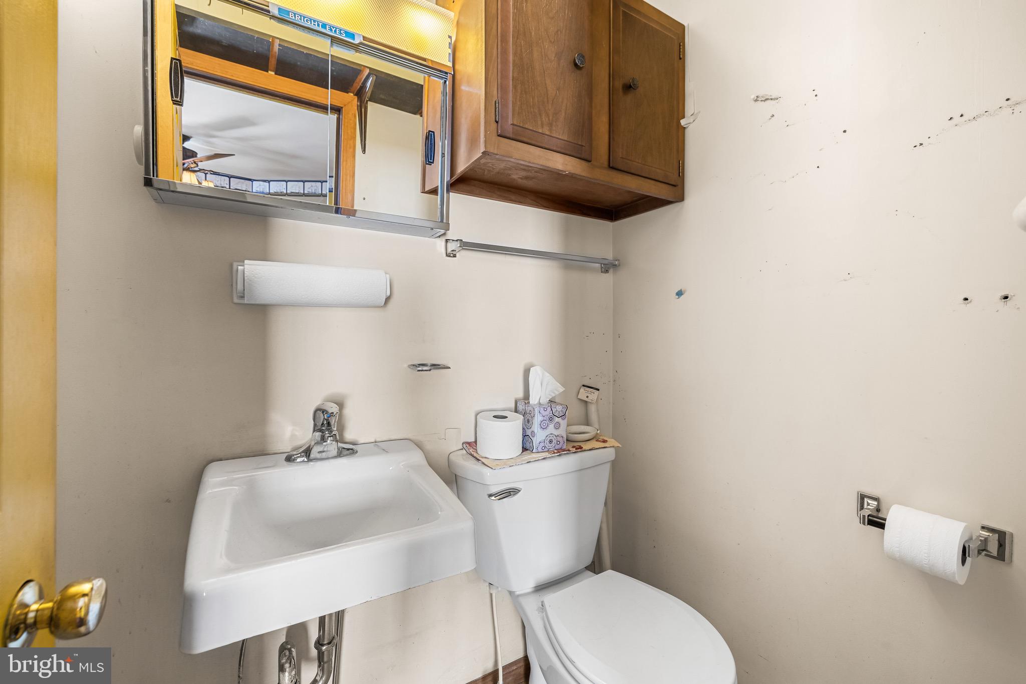 1421 North Main Street Hampstead, MD 21074 - Photo 25 of 44 a bathroom with a toilet sink and mirror