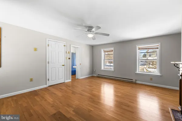 a view of a kitchen with a sink dishwasher stove and kitchen view with wooden floor