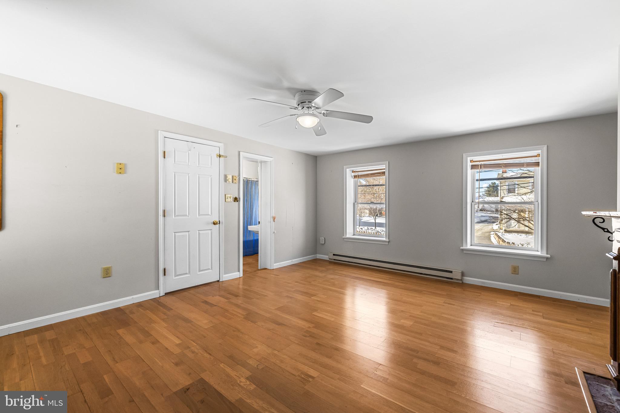 1421 North Main Street Hampstead, MD 21074 - Photo 27 of 44 a view of an empty room with a window and wooden floor