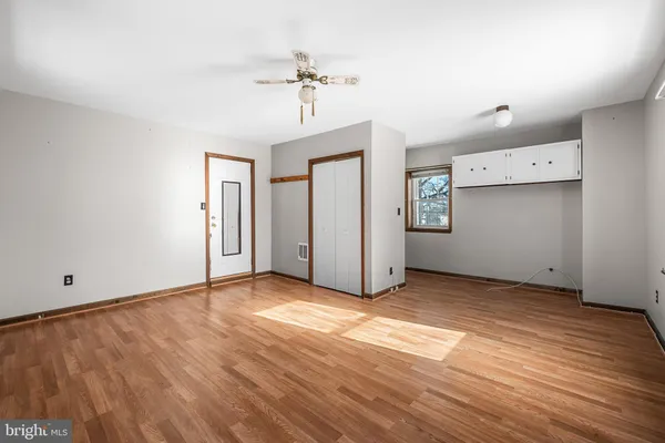 a view of a room with window and wooden floor