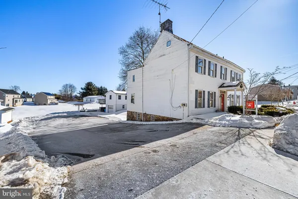 a view of an entryway with wooden floor and windows