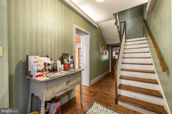 a view of an entryway with furniture and stairs