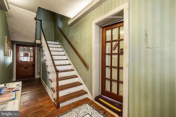 an empty room with windows and fireplace