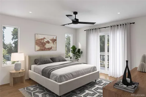 a bedroom with a large bed and a chandelier