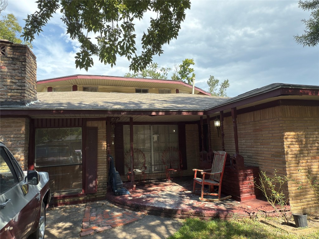 a view of a patio with table and chairs and potted plants