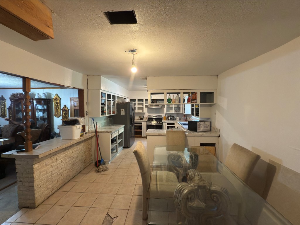 10106 Cheeves Drive Houston, TX 77016 - Photo 7 of 12 a dining hall with stainless steel appliances granite countertop a couch and a living room view