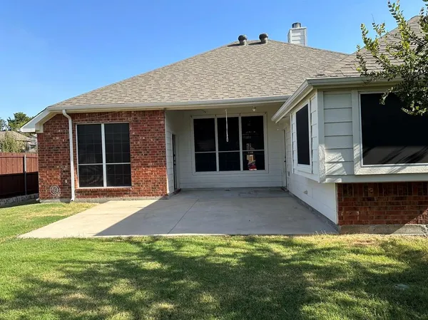 a view of a house with yard and sitting area