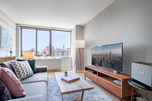 a living room with furniture and a large window
