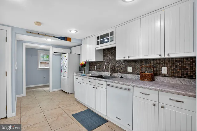 a kitchen with stainless steel appliances granite countertop a refrigerator sink and cabinets