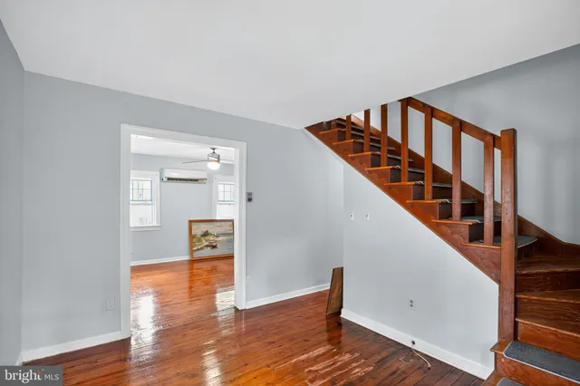 a view of entryway and hall with wooden floor