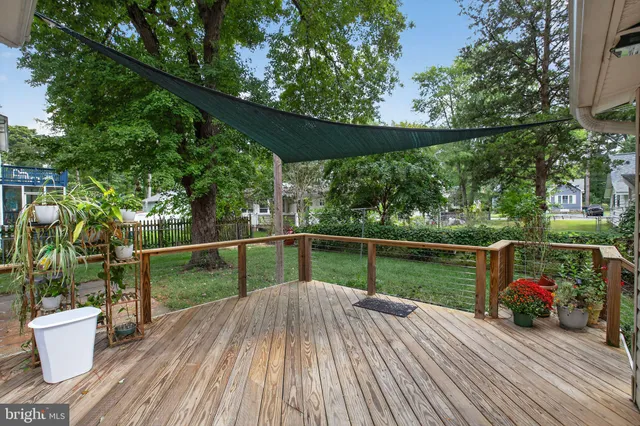 a view of house with deck and seating space