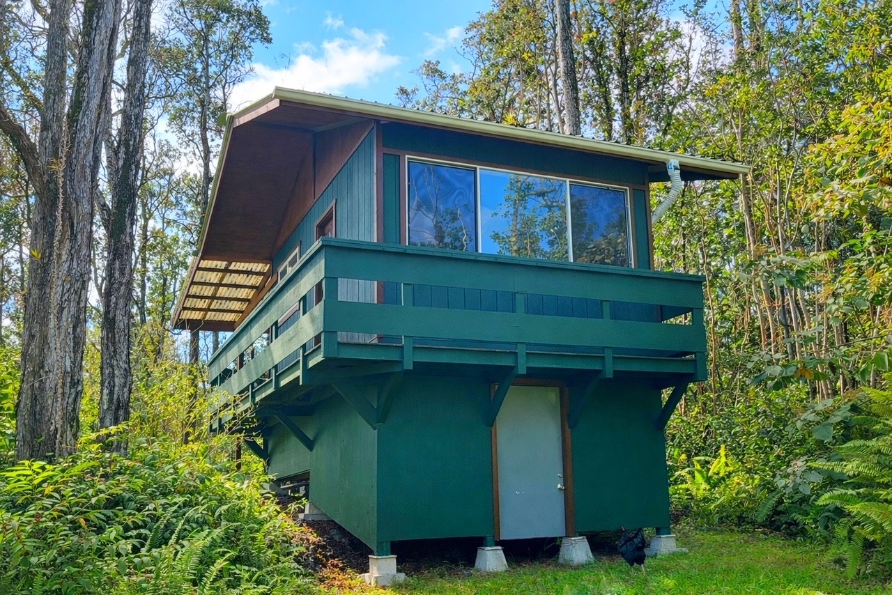 12-4275 Upper Puna Road Pahoa, HI 96778 - Photo 3 of 22 a front view of a house with a yard