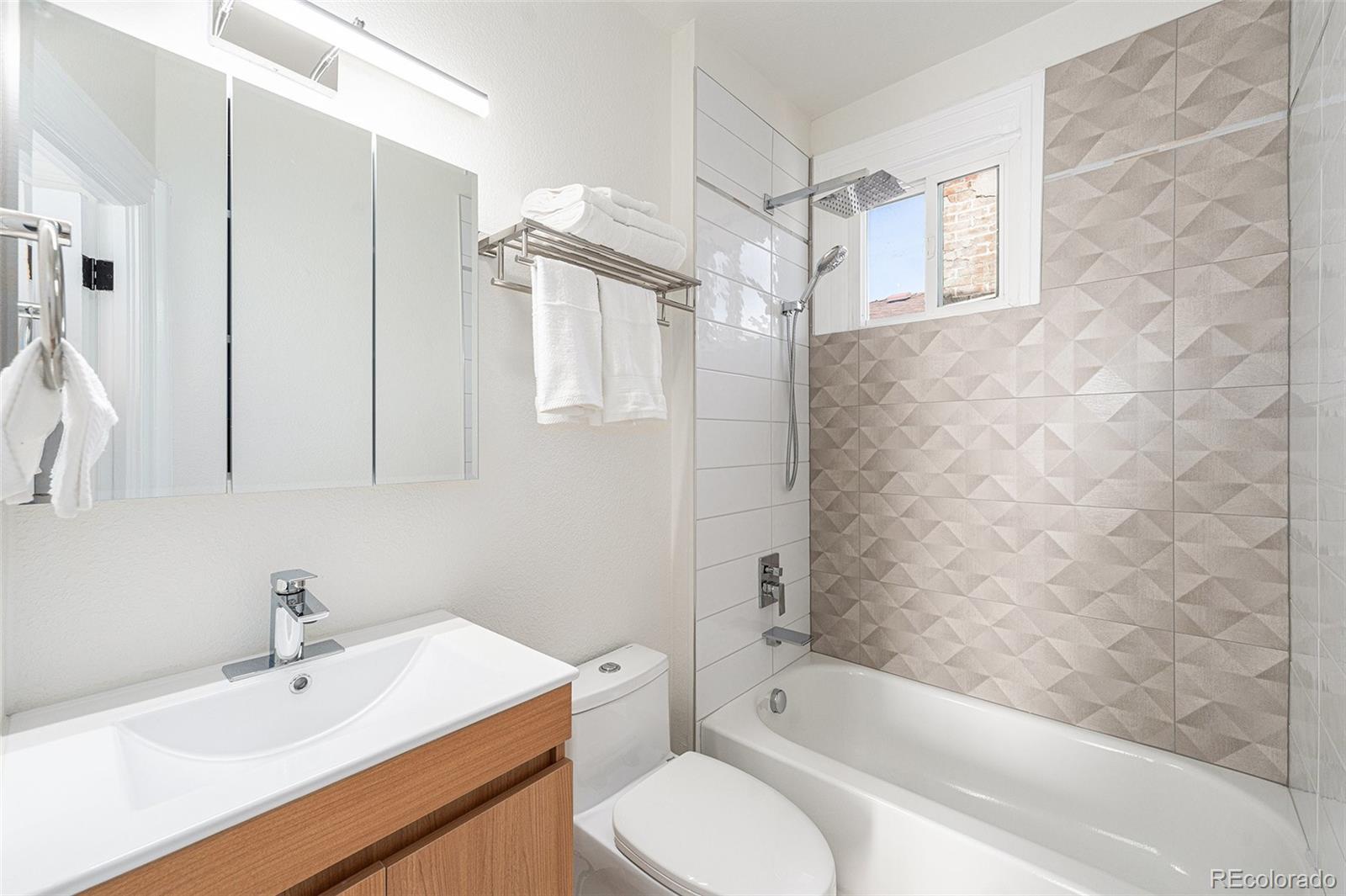 300 Inca Street Denver, CO 80223 - Photo 13 of 20 a bathroom with a sink toilet and shower