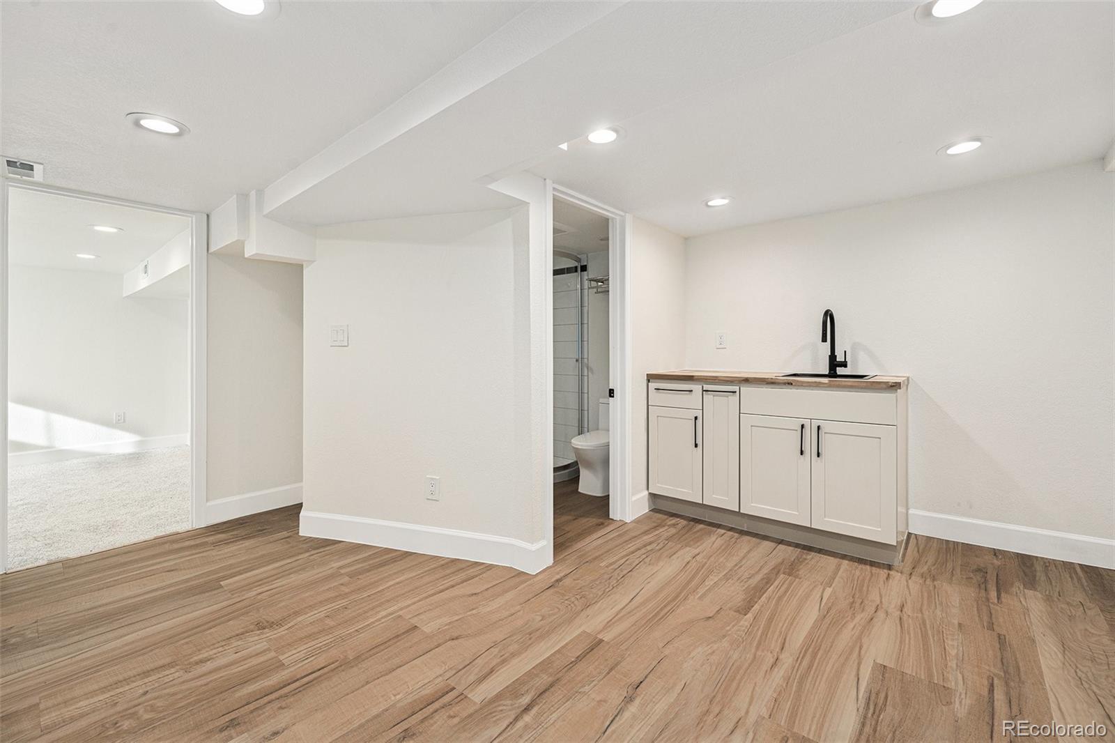 300 Inca Street Denver, CO 80223 - Photo 15 of 20 a kitchen with a sink wooden floor and a window