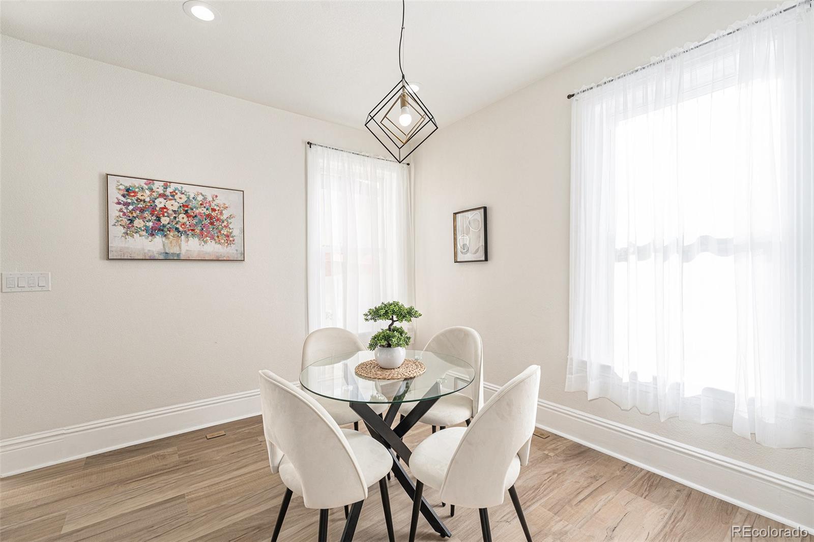 300 Inca Street Denver, CO 80223 - Photo 7 of 20 a view of a dining room with furniture window and wooden floor