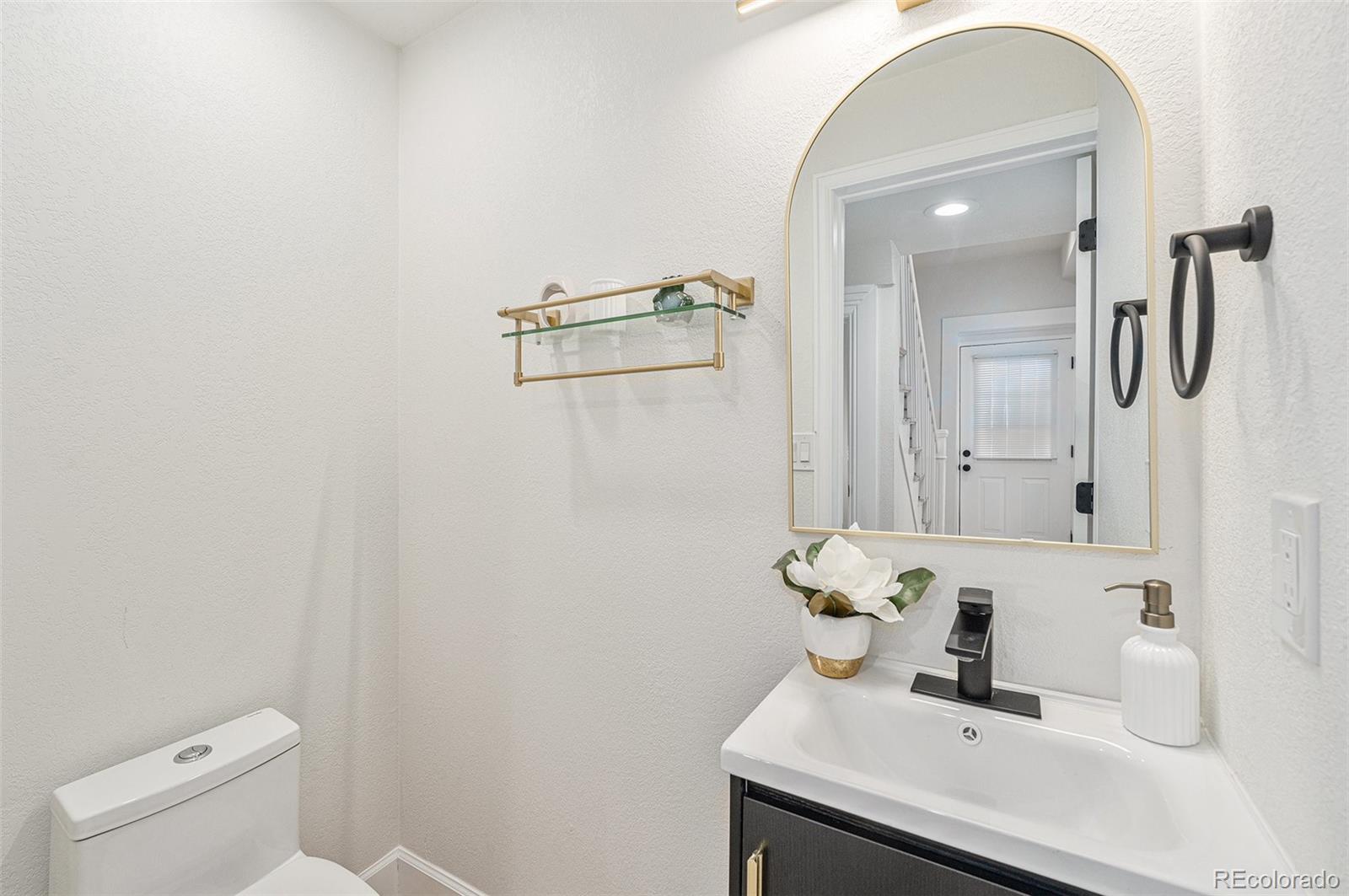 300 Inca Street Denver, CO 80223 - Photo 8 of 20 a bathroom with a sink toilet and shower