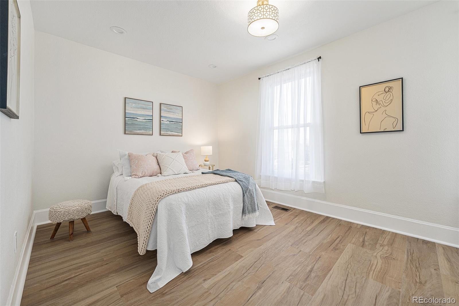 300 Inca Street Denver, CO 80223 - Photo 9 of 20 a bedroom with a bed and a window
