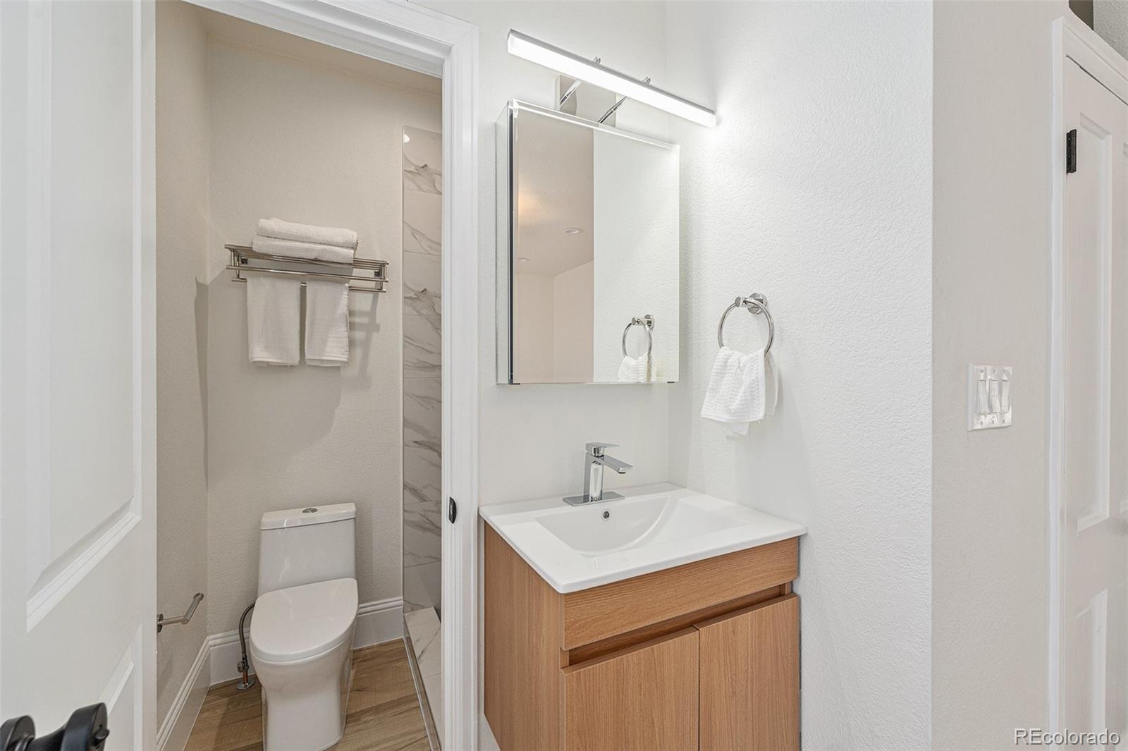 300 Inca Street Denver, CO 80223 - Photo 10 of 20 a bathroom with a sink toilet and shower