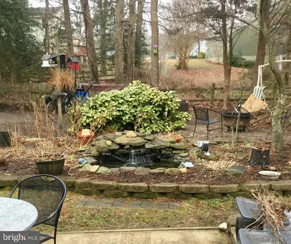a backyard of a house with a yard and outdoor seating