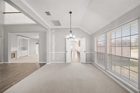 a large kitchen with stainless steel appliances granite countertop plenty wooden cabinets counter space and wooden floor