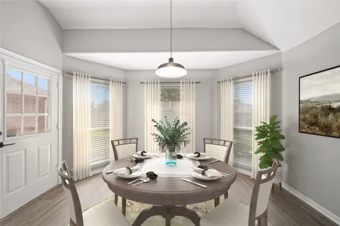 a large white kitchen with a sink and a refrigerator