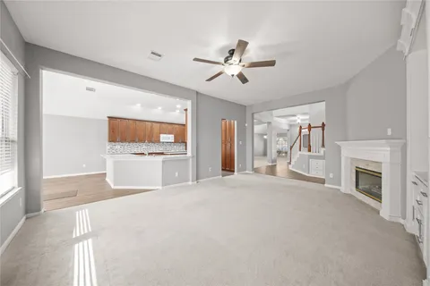 a view of an empty room with a fireplace and a window