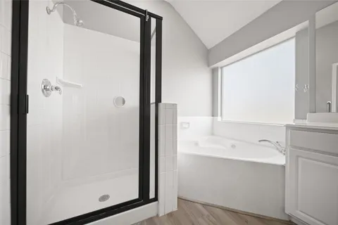 an empty room with ceiling fan and window