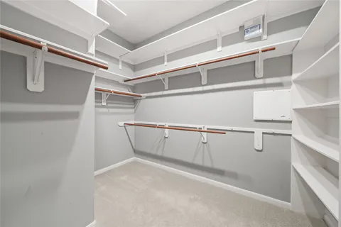 a bedroom with a large bed and a chandelier fan