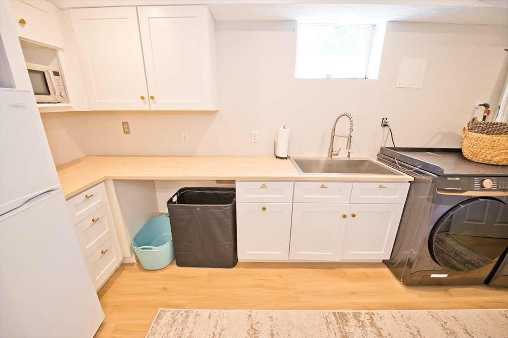 16 Warren Avenue Newton, MA 02465 - Photo 27 of 42 a kitchen with a sink and cabinets
