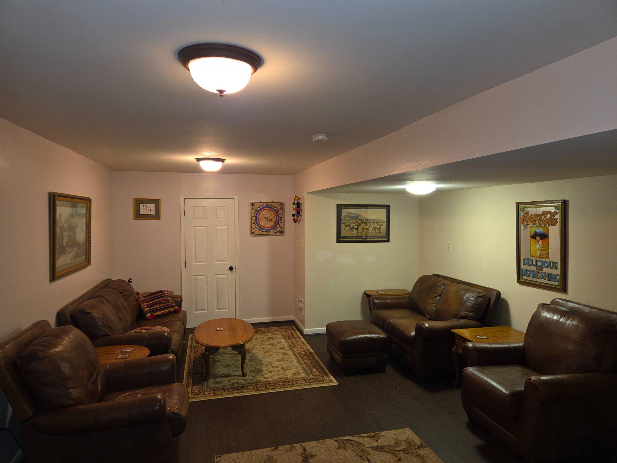 151 Martz Road Sykesville, MD 21784 - Photo 53 of 74 Cozy Basement Living Room with warm lighting.