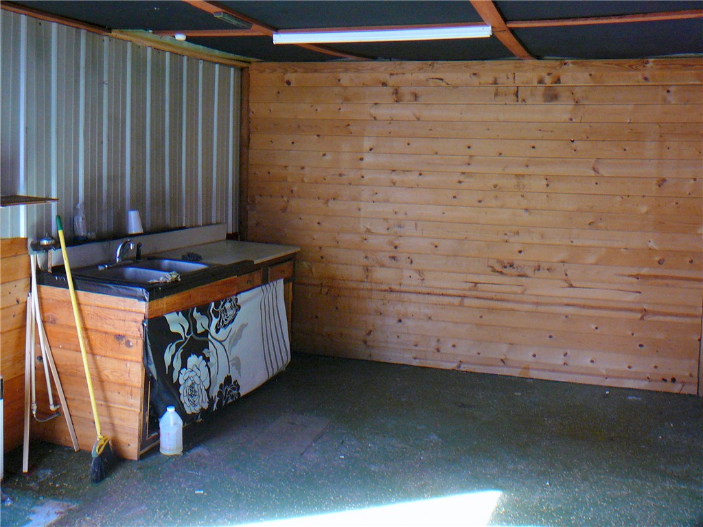 2 Sirrine Street Honea Path, SC 29654 - Photo 10 of 10 This versatile workshop area features durable wood paneling and a functional utility sink.