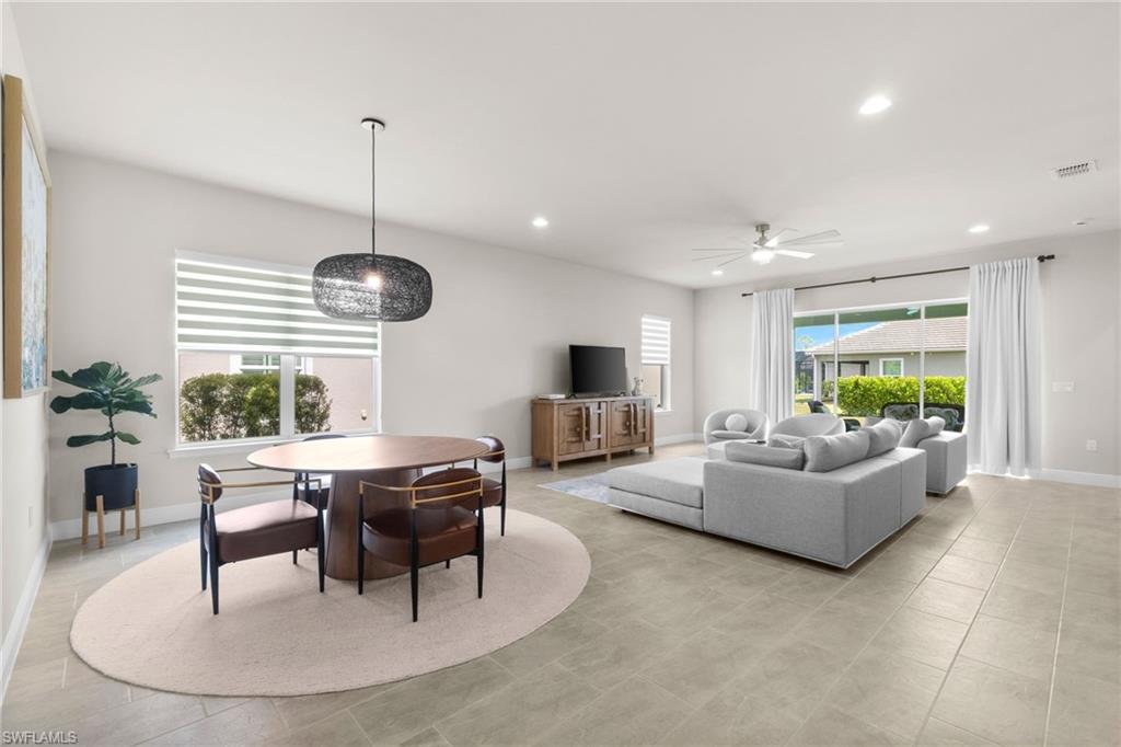 3419 Pilot Circle Naples, FL 34120 - Photo 10 of 39 a living room with furniture kitchen view and a large window