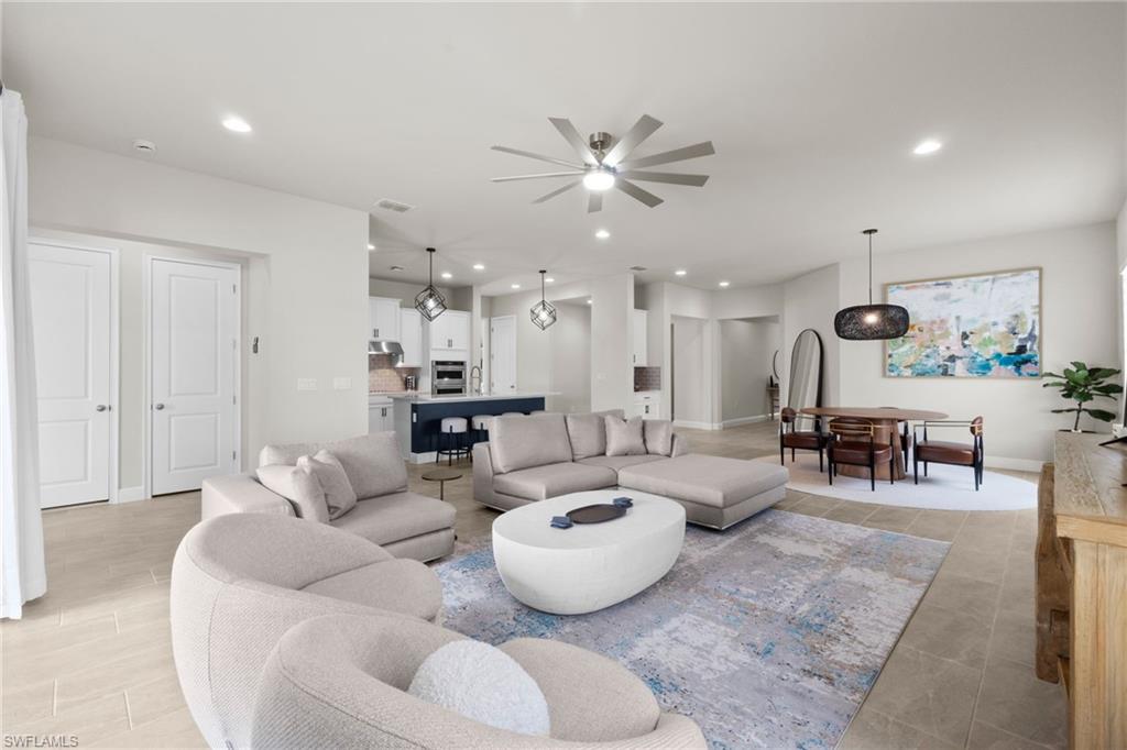 3419 Pilot Circle Naples, FL 34120 - Photo 12 of 39 a living room with furniture and a large window