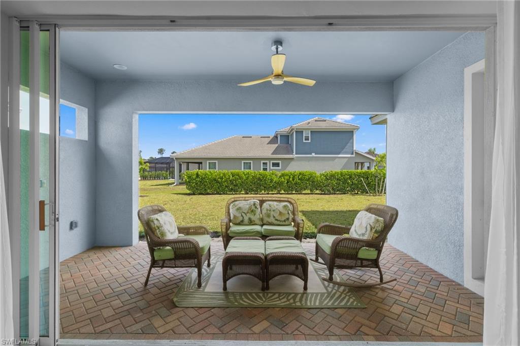 3419 Pilot Circle Naples, FL 34120 - Photo 13 of 39 a view of a dining room with furniture one side kitchen view and wooden floor