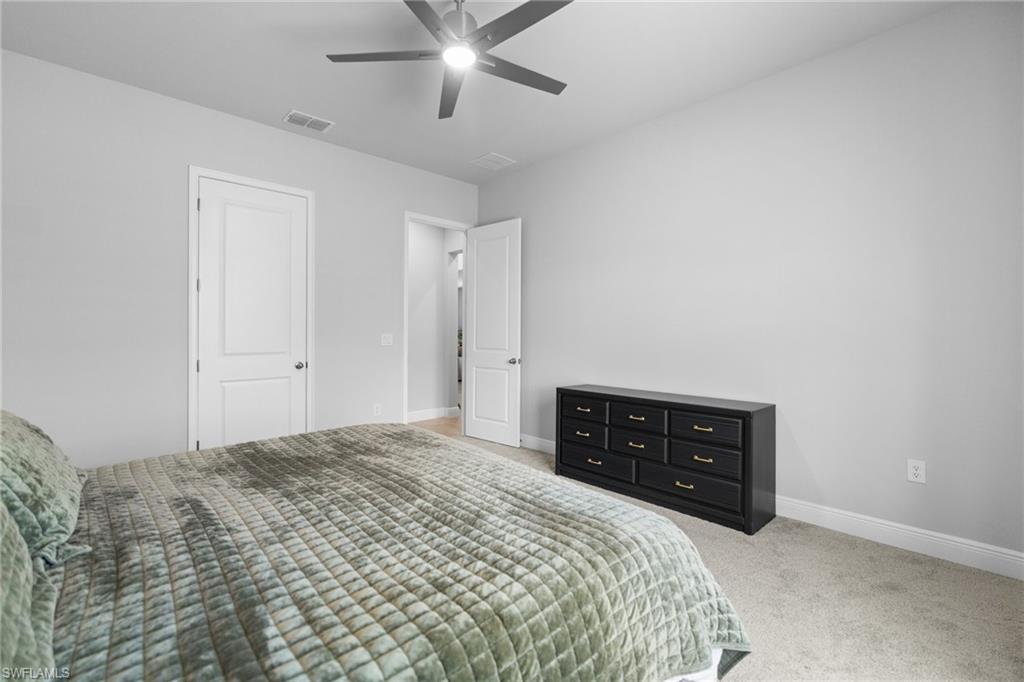 3419 Pilot Circle Naples, FL 34120 - Photo 17 of 39 a bedroom with a bed and a dresser