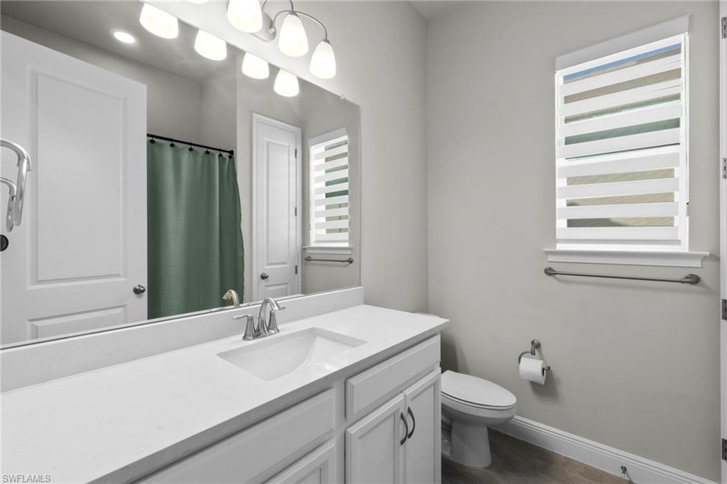 3419 Pilot Circle Naples, FL 34120 - Photo 21 of 39 a bathroom with a sink a toilet and mirror
