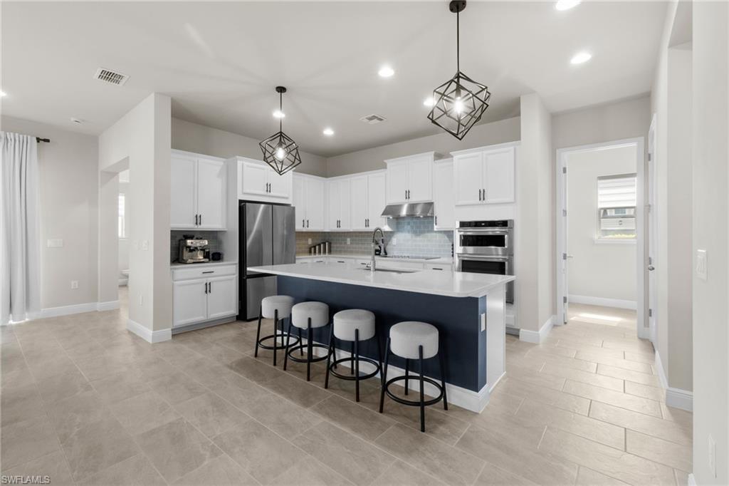 3419 Pilot Circle Naples, FL 34120 - Photo 26 of 39 a large kitchen with a table and chairs