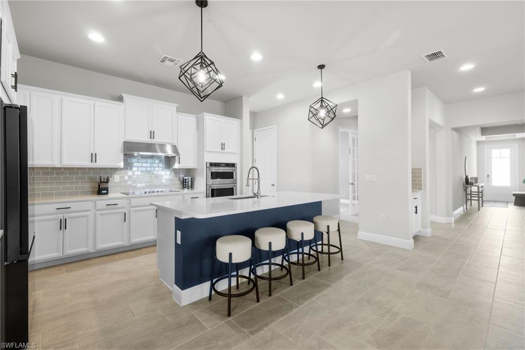 3419 Pilot Circle Naples, FL 34120 - Photo 3 of 39 a kitchen with refrigerator cabinets and a sink