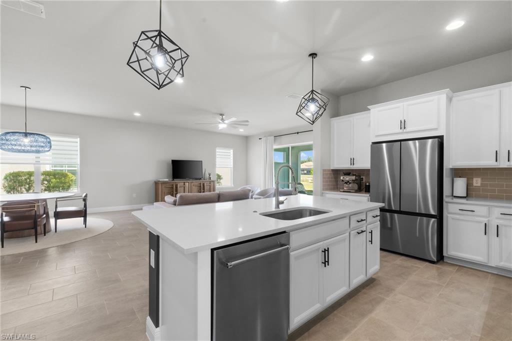 3419 Pilot Circle Naples, FL 34120 - Photo 39 of 39 a kitchen that has a lot of cabinets and wooden floor