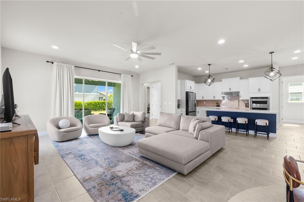 3419 Pilot Circle Naples, FL 34120 - Photo 8 of 39 a living room with furniture and a flat screen tv