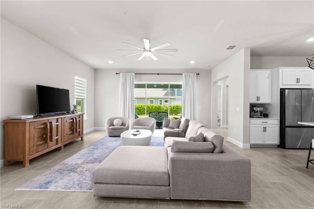 3419 Pilot Circle Naples, FL 34120 - Photo 9 of 39 a living room with furniture and a flat screen tv