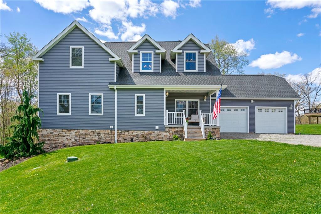 a front view of a house with a yard and garage