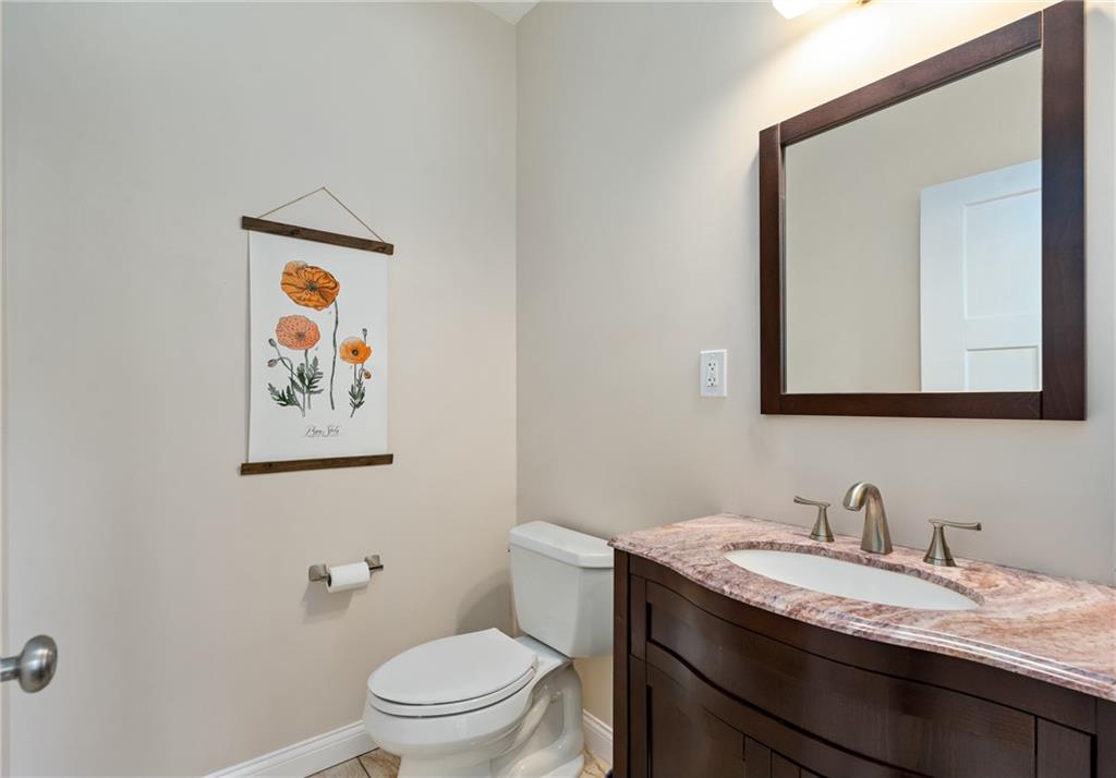 2175 Lovi Road Freedom, PA 15042 - Photo 18 of 36 a bathroom with a granite countertop toilet a sink and a mirror
