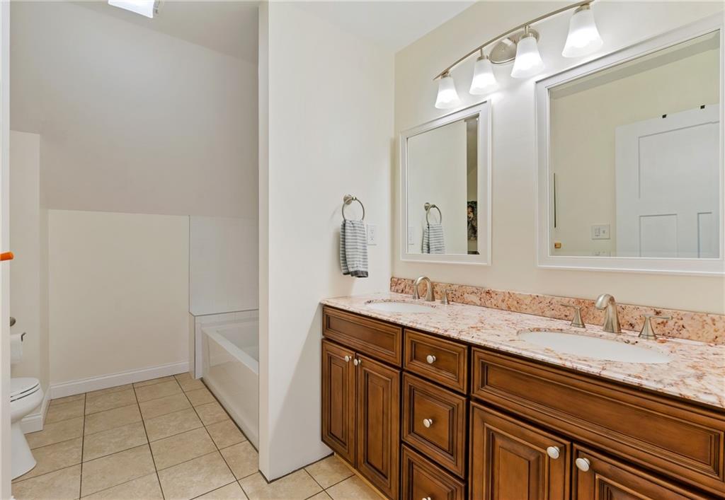 2175 Lovi Road Freedom, PA 15042 - Photo 25 of 36 a bathroom with a granite countertop sink and a mirror