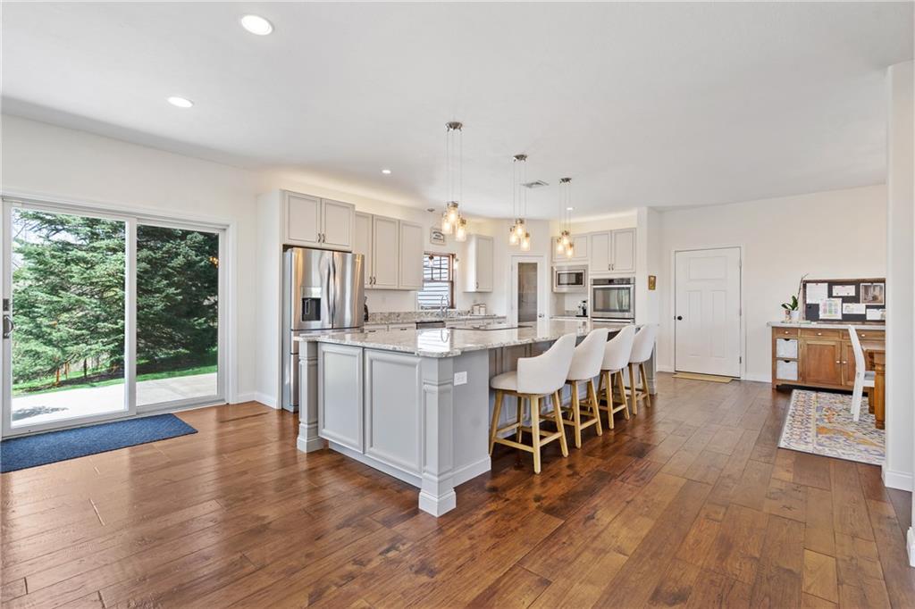 2175 Lovi Road Freedom, PA 15042 - Photo 5 of 36 a kitchen with stainless steel appliances a dining table chairs and wooden floor