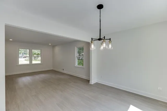 a large kitchen with stainless steel appliances granite countertop a lot of counter space and wooden floor