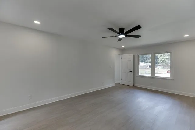 an empty room with entrance and windows