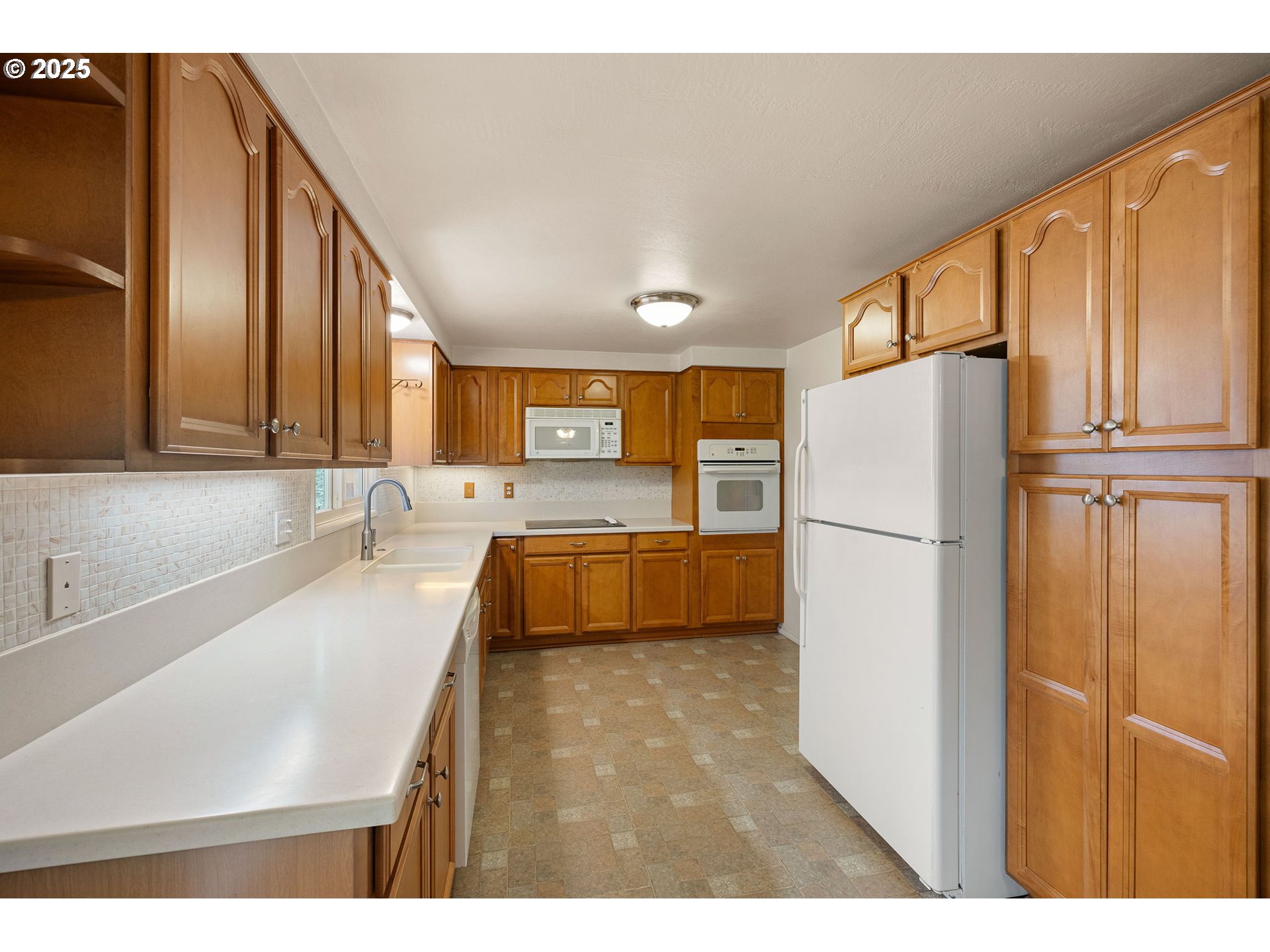 2030 Valhalla Street Eugene, OR 97401 - Photo 15 of 45 a kitchen with stainless steel appliances a refrigerator and a sink